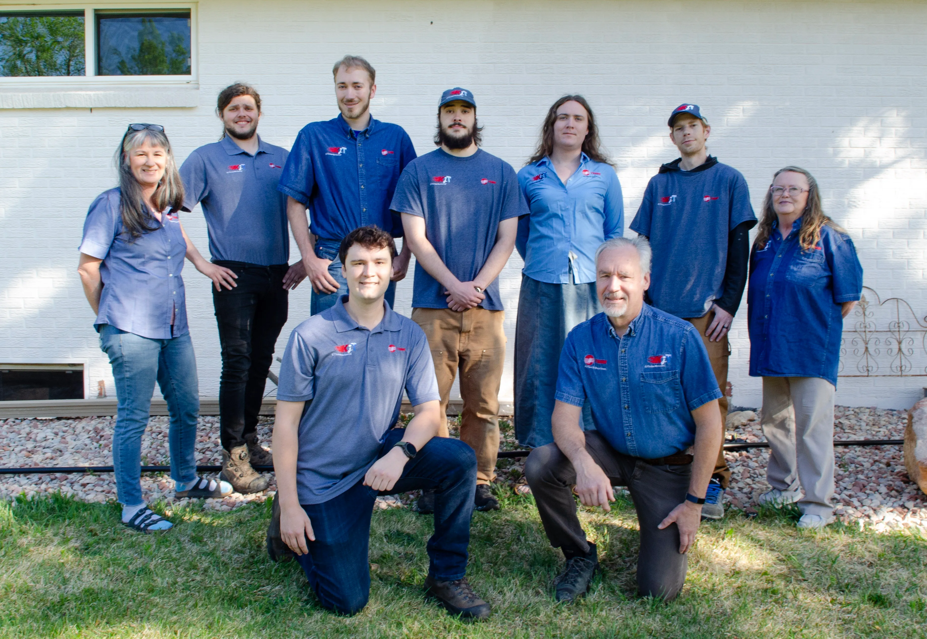 The KJ Thomas Mechanical team standing together outside the shop.