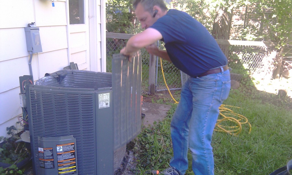 Karl cleans and checks the outside AC unit
