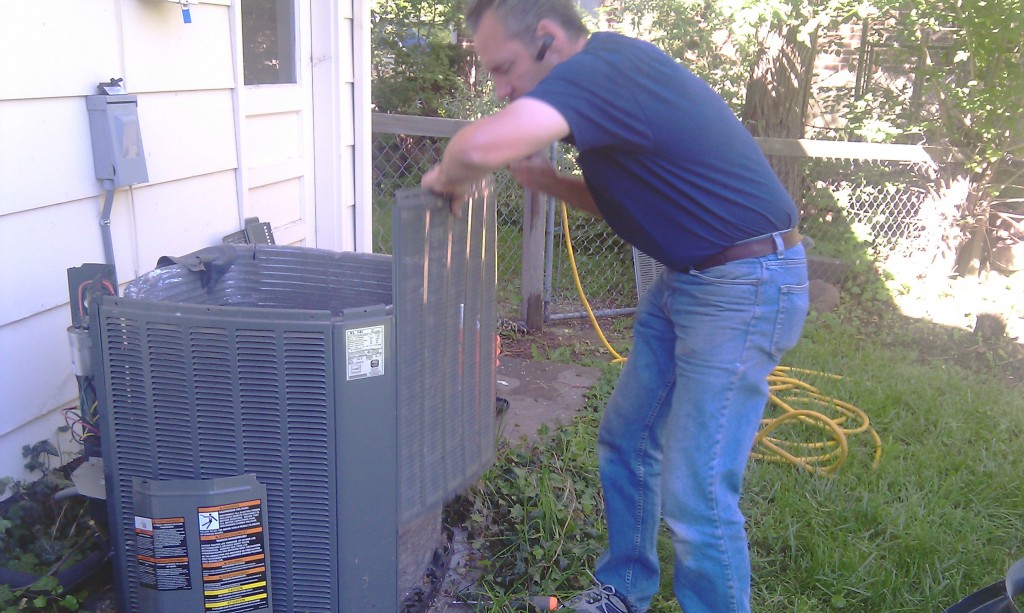 Karl cleans and checks the outside AC unit